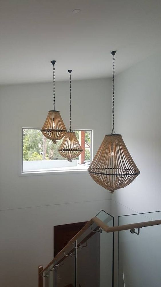 Three pendant lights hanging above a staircase, installed by Mylec in North Wollongong, NSW